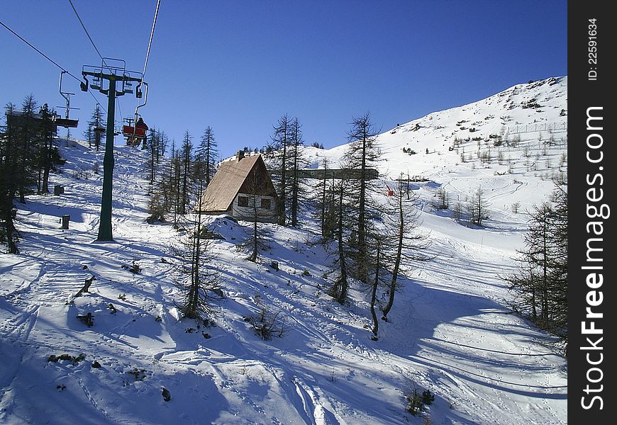 Alpine chalet on a snow covered alp
