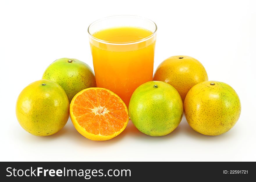 Tangerines and juice glass on white background