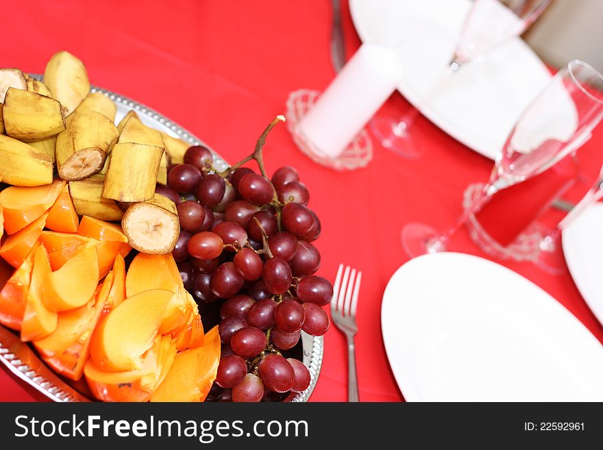 Served table with plates and fruits