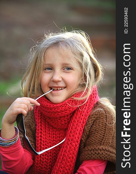 Portrait of blond girl smiling outside autumn day. Portrait of blond girl smiling outside autumn day