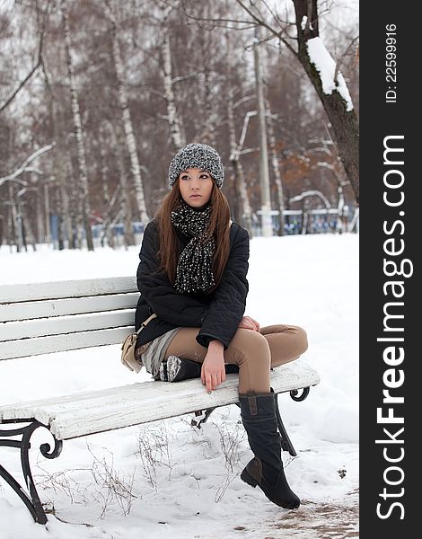 Girl on a bench in the winter