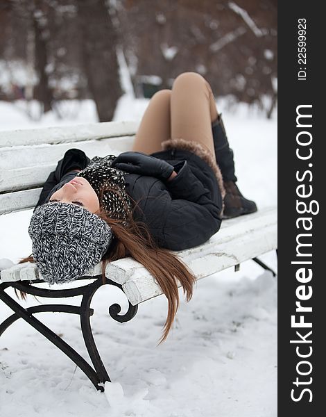 Girl on a bench in the winter
