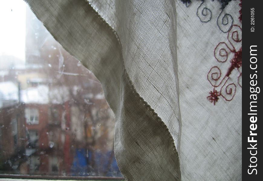 Window, curtains on rainy day
