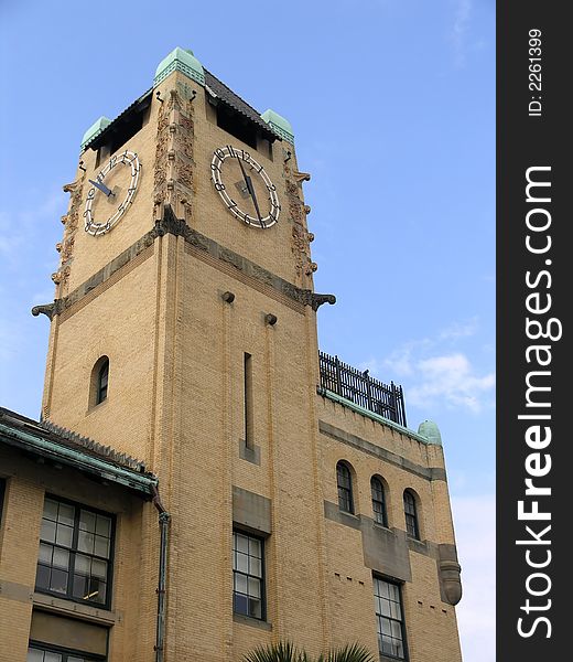 Historic Clocktower with dual clocks against blue sky