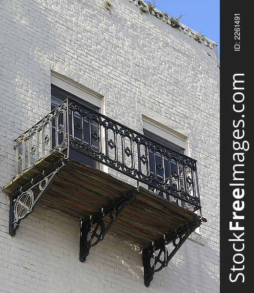 Historic wrought iron black Porch on white building. Historic wrought iron black Porch on white building