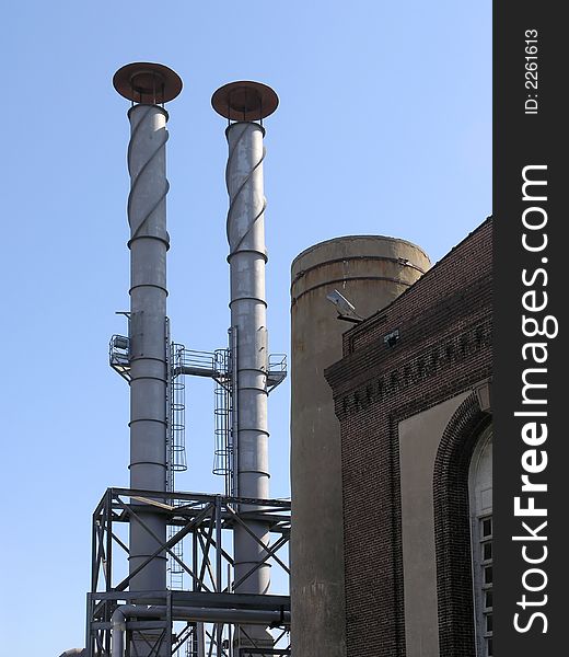Power Station with two exhaust stacks against blue sky. Power Station with two exhaust stacks against blue sky