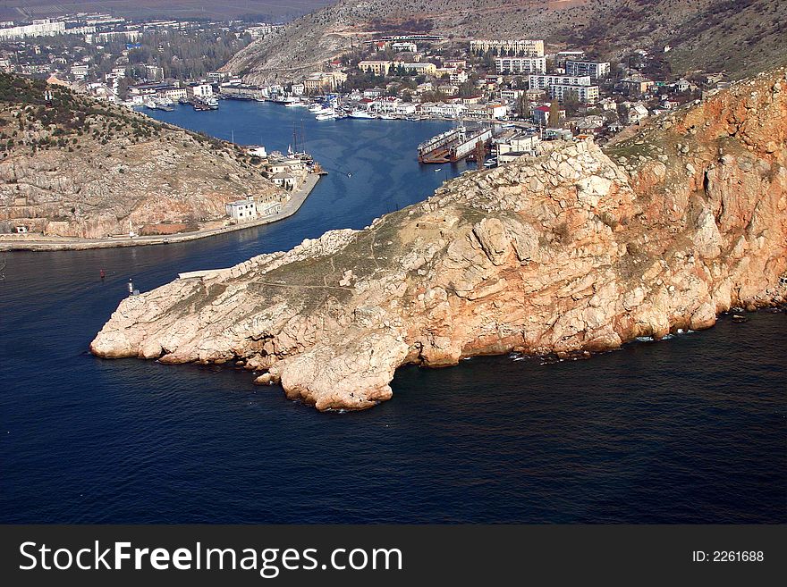 City on coast of a sea bay among rocks. City on coast of a sea bay among rocks