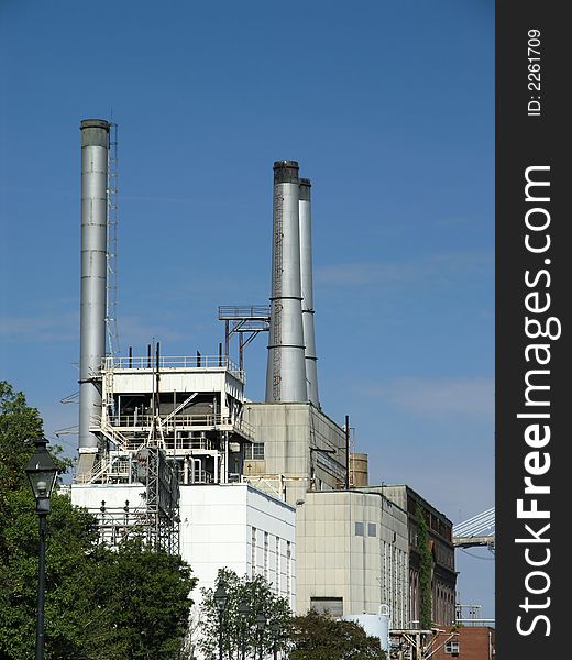 Power Station with three exhaust stacks against blue sky. Power Station with three exhaust stacks against blue sky