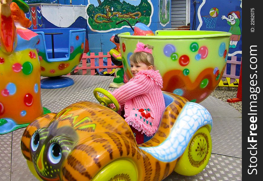 Girl having fun ride on merry go round. Girl having fun ride on merry go round.