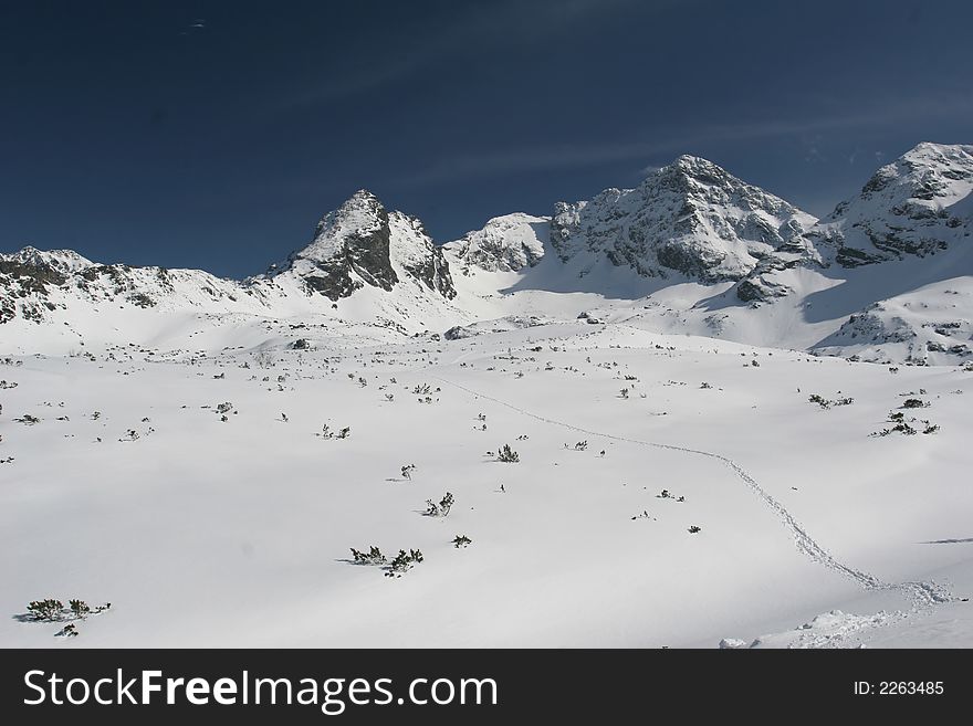 Mountains covered  white snow in the winter day. Mountains covered  white snow in the winter day