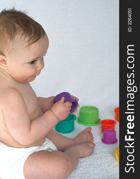 Image of adorable baby playing with stacking cups. Image of adorable baby playing with stacking cups