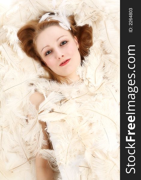 Young woman covered with ostrich feathers. Young woman covered with ostrich feathers