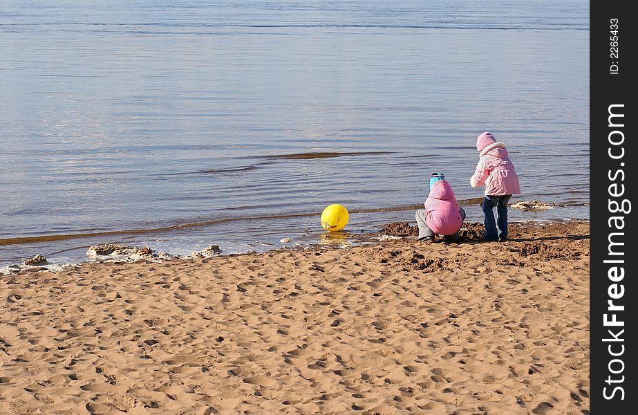 Two little girls play on the beach. Two little girls play on the beach