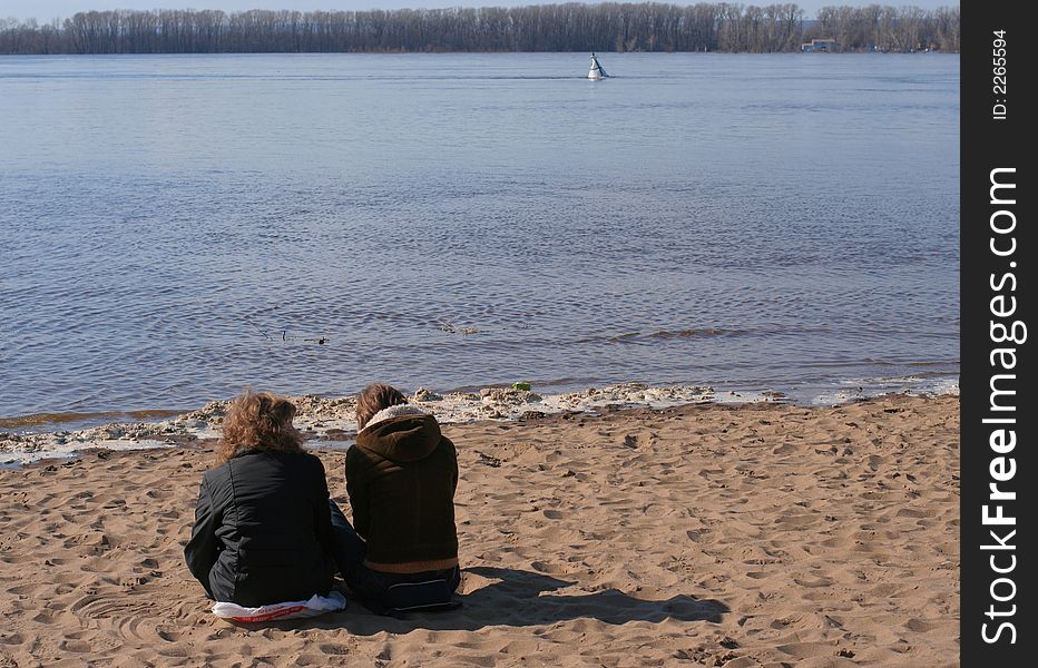 Two young girls sitting on the beach. Two young girls sitting on the beach