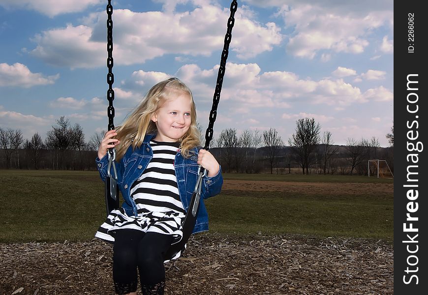 Photo of a girl swinging in a park