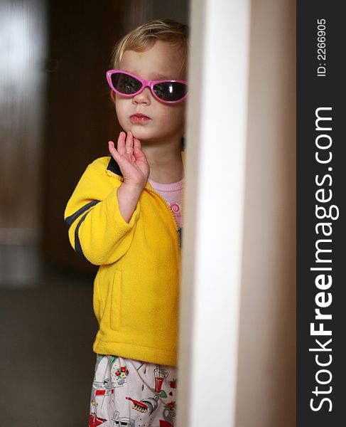 A little girl wearing sunglasses. A little girl wearing sunglasses