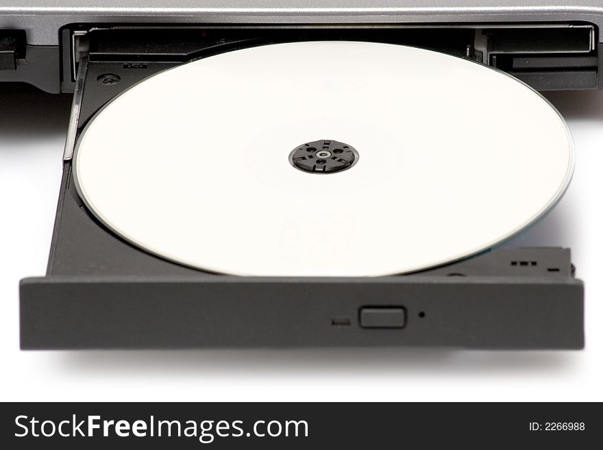 Blank CD in a notebook drive. White background. Blank CD in a notebook drive. White background.