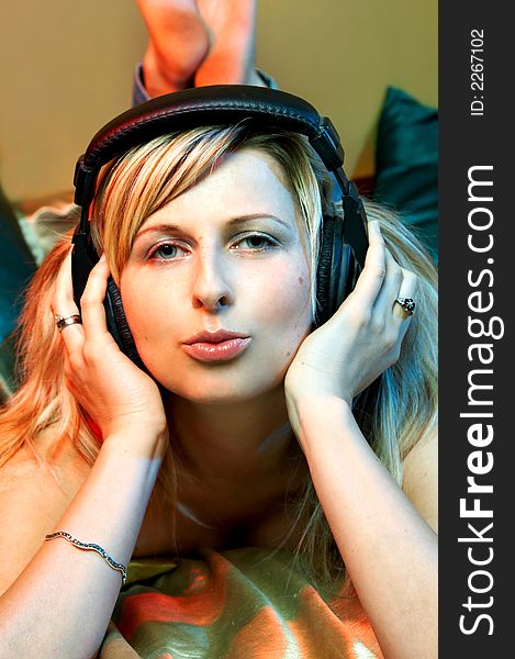 Girl is listening to music through headphones