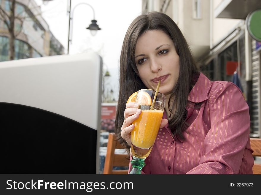 Businesswoman sitting in cafe and working on laptop
