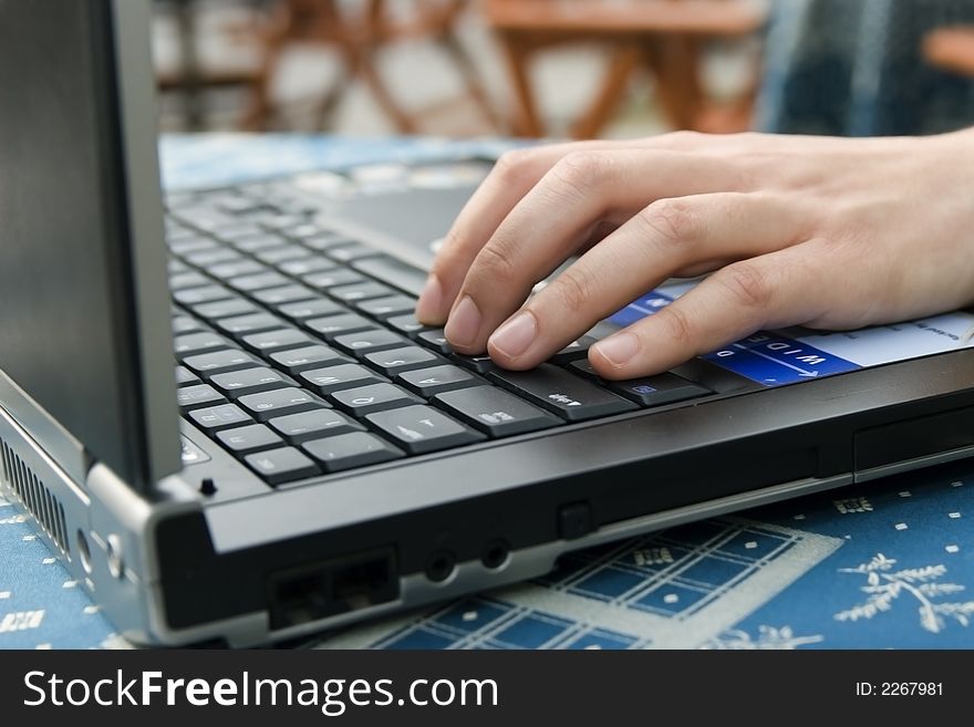 Woman in cafe working on laptop