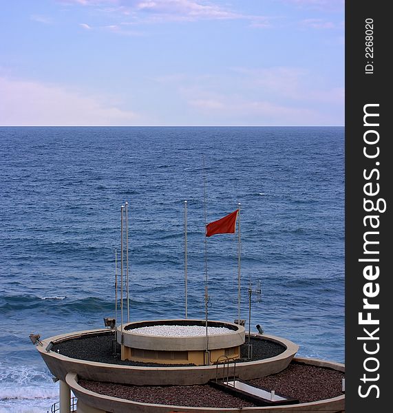 A newly built lifeguard tower with reg flag up to prevent swimming. A newly built lifeguard tower with reg flag up to prevent swimming