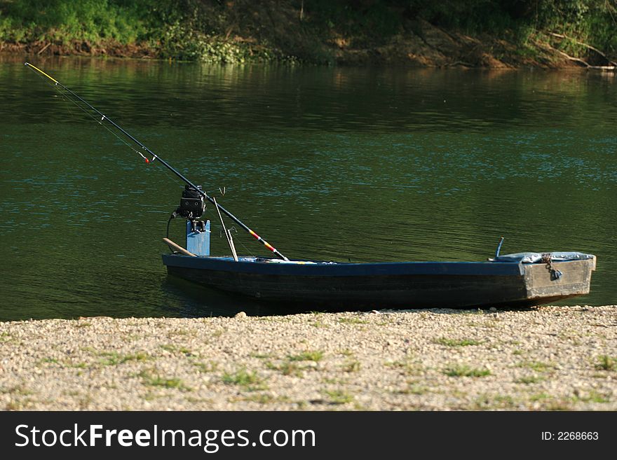 Fishermans boat on green riverside