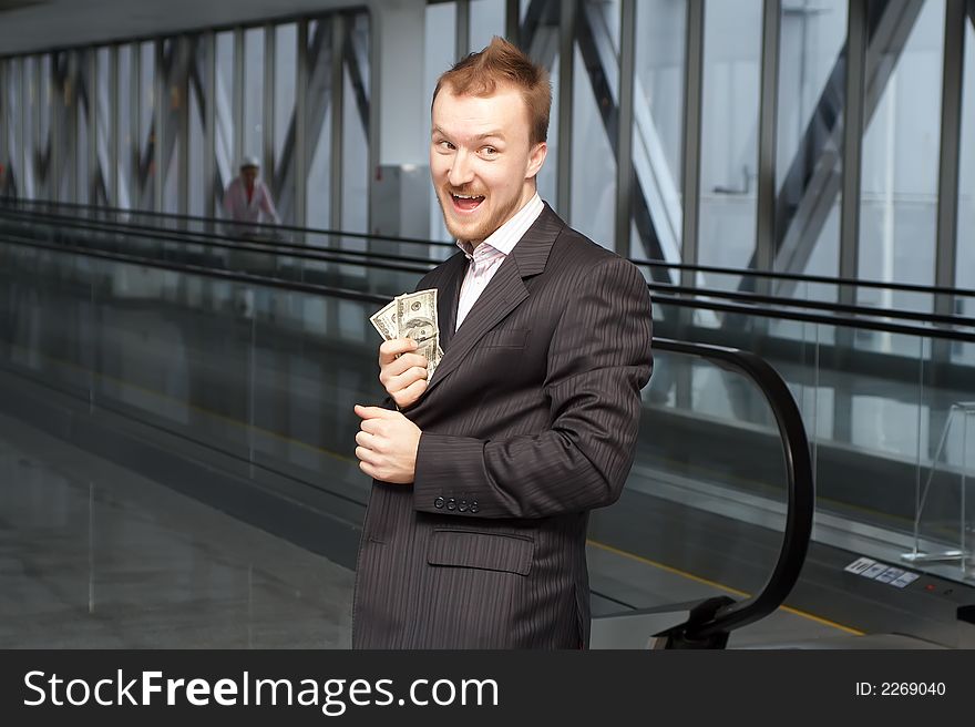 Businessman showing money because of a top of a jacket. Businessman showing money because of a top of a jacket