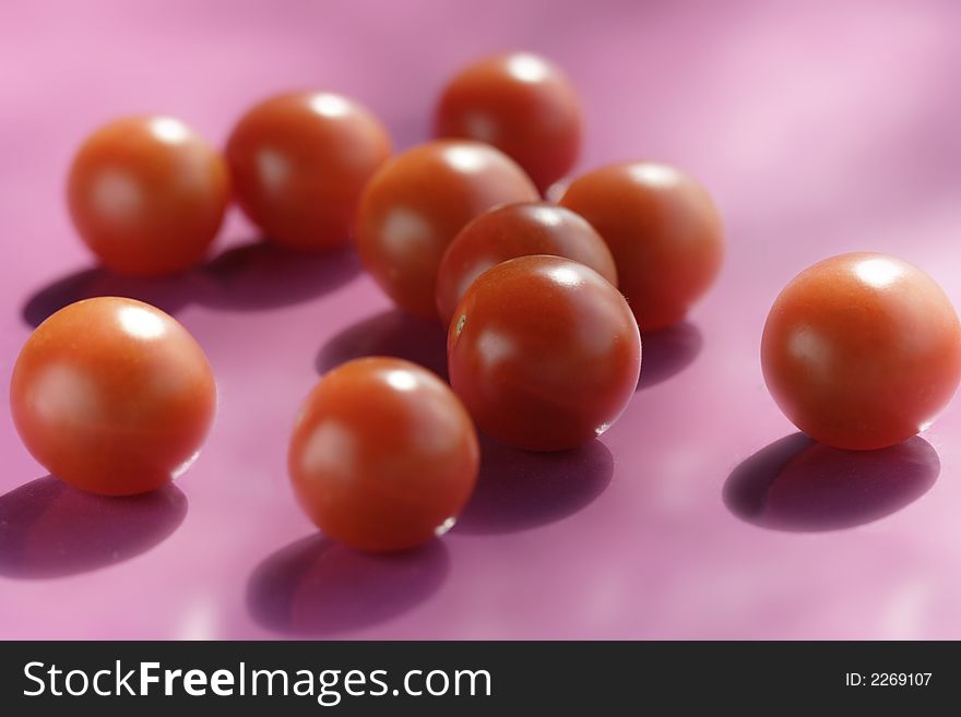 Cherry tomatoes on purple background
