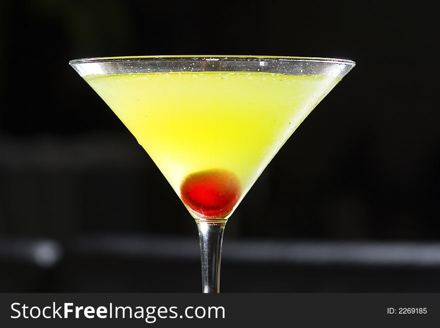 An isolated martini cocktail glass with cherries. An isolated martini cocktail glass with cherries