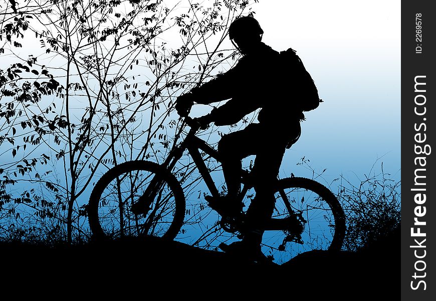 Mountain biker silhouette with clean blue sky