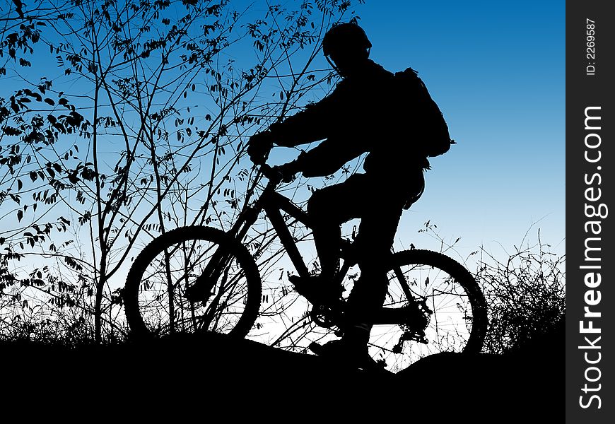 Mountain biker silhouette with clean blue sky