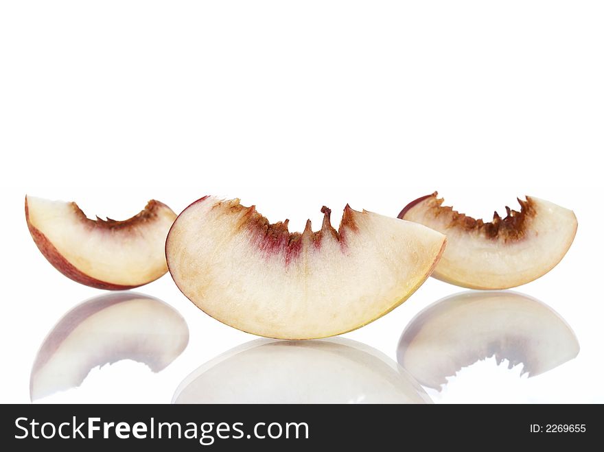 Fresh colored peaches on white background