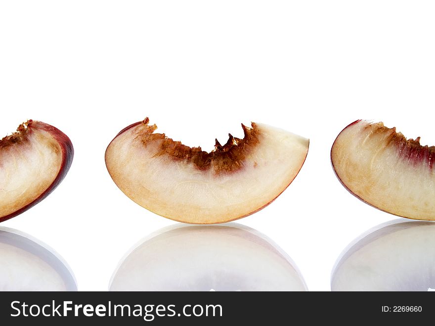 Fresh colored peaches on white background