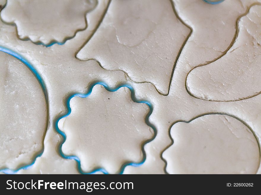 A rolled out dough for biscuits with cookie cutter