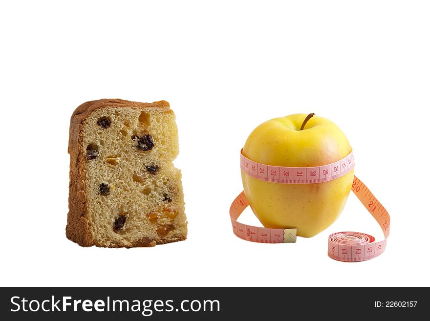 Pies of panettone and fresh yellow apple with measuring tape isolated on white. Pies of panettone and fresh yellow apple with measuring tape isolated on white
