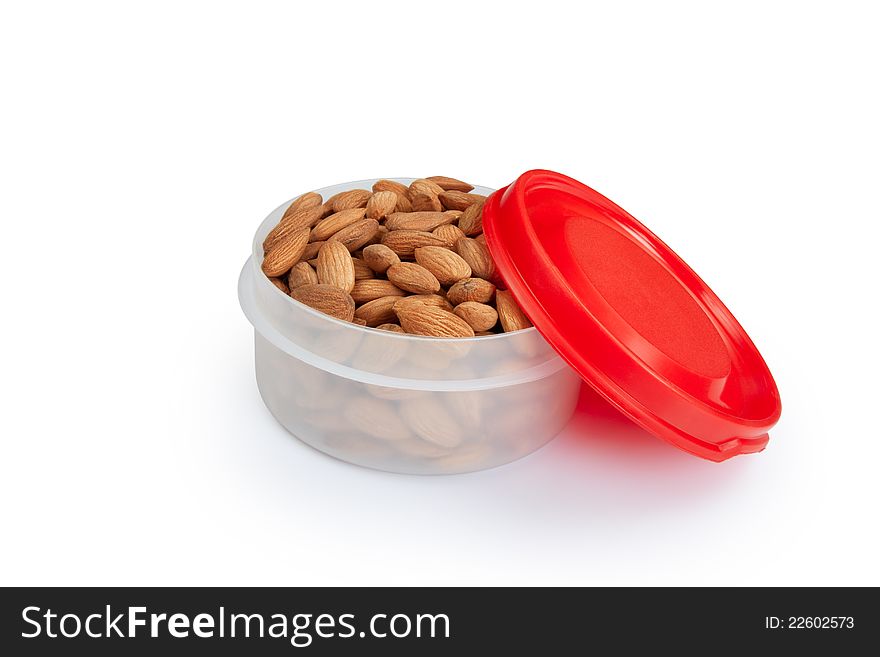 Pile of  almonds in white plastic box  isolated over white background