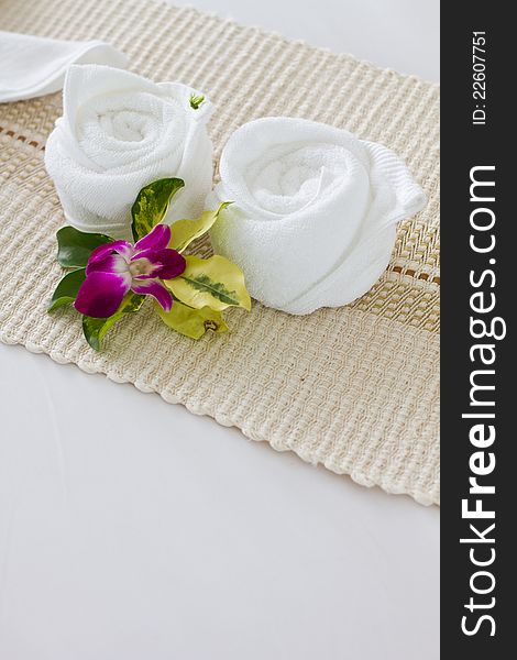 Decorative towel and flower on the bed. Decorative towel and flower on the bed