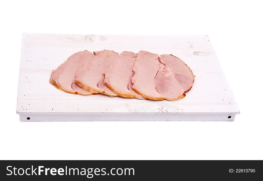 Ham slices on white wooden board, isolated