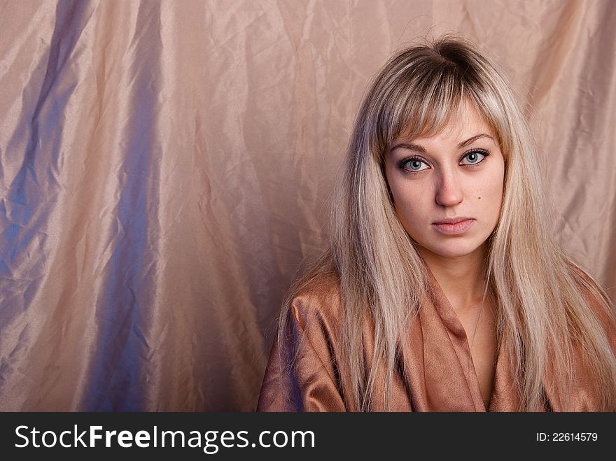 Portrait of girl on a background beige fabric. Blonde. Portrait of girl on a background beige fabric. Blonde.