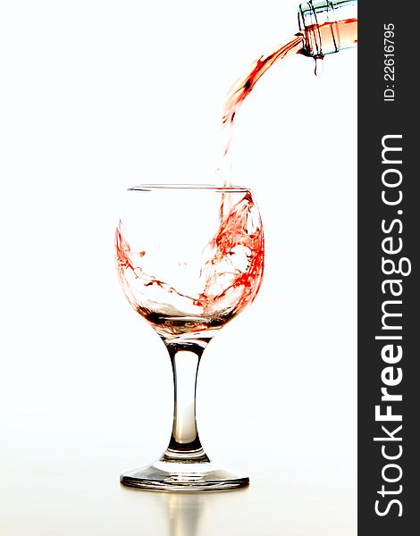 Pouring rose wine in glass isolated on white background. Pouring rose wine in glass isolated on white background