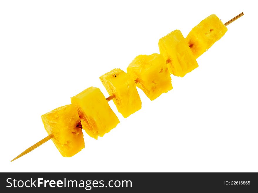 Fresh, raw pineapple chunks nailed on wooden stick isolated over white background.