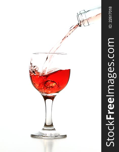 Pouring rose wine in glass isolated on white background. Pouring rose wine in glass isolated on white background