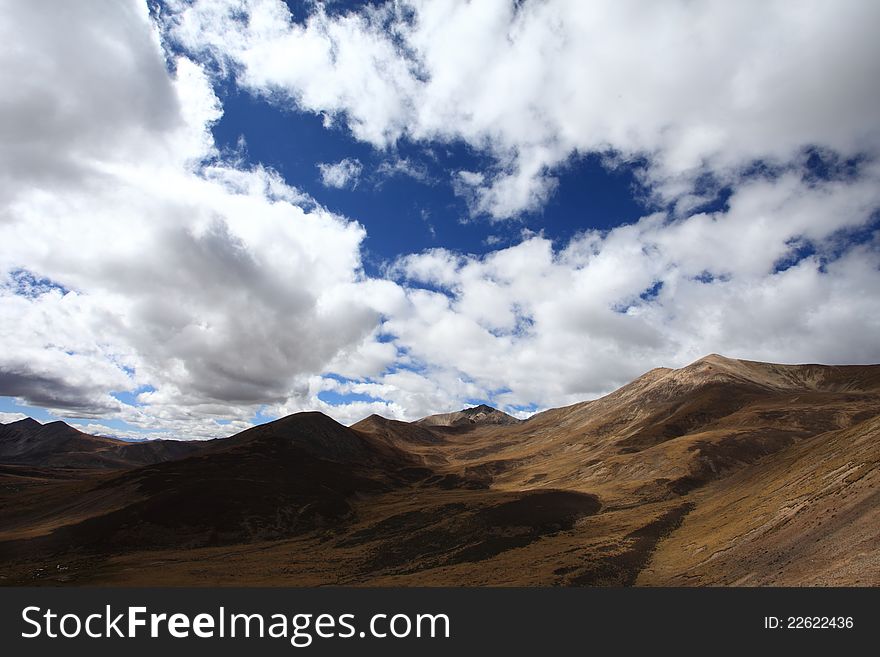 White clouds and brown mountains. White clouds and brown mountains