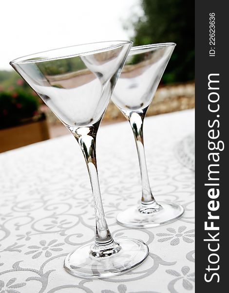 Close up of Two Martini glasses on an outside table during a wedding