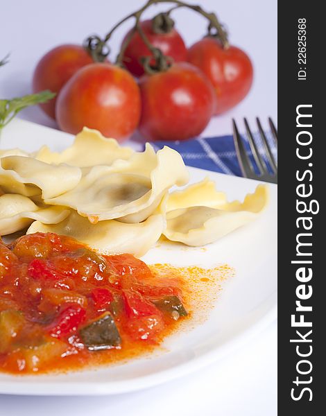Stuffed Raviolis of mushrooms with a sauce of tomato with vegetables