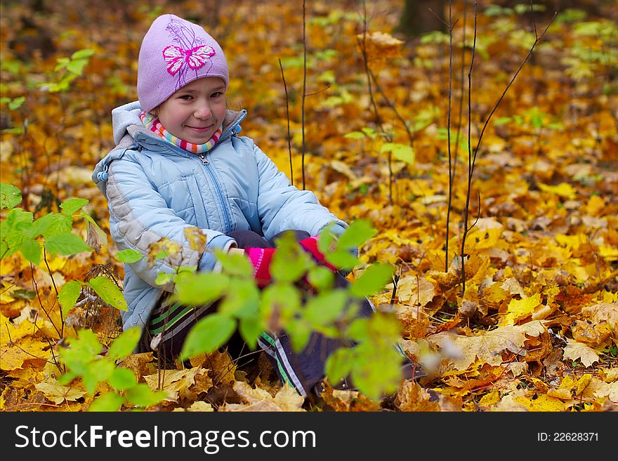 Girls kid smiling in autumn leaves background, horizontal image