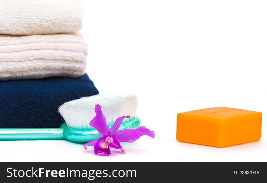 Towels,soap and orchid,beautify spa concept,on white background. Towels,soap and orchid,beautify spa concept,on white background