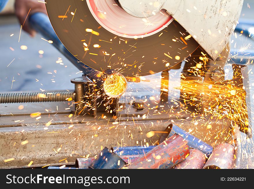 Image of The smith are cutting steel with electric saw