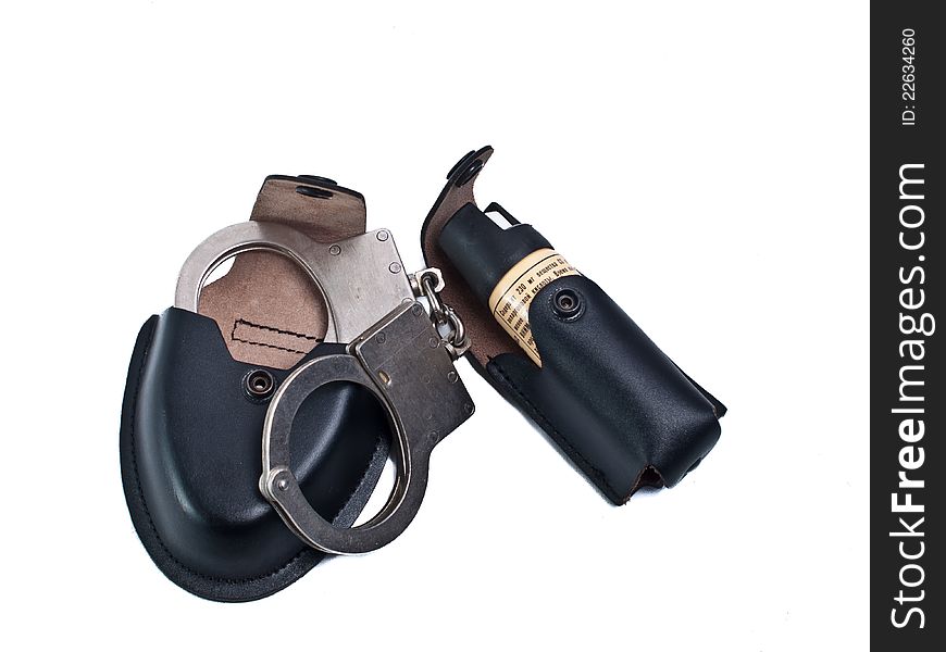 Manacles and gas pulverizer for police body in black leather case on white background