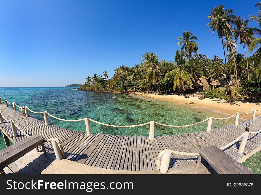 Bridge lead to tropical beach in a turquoise seascape